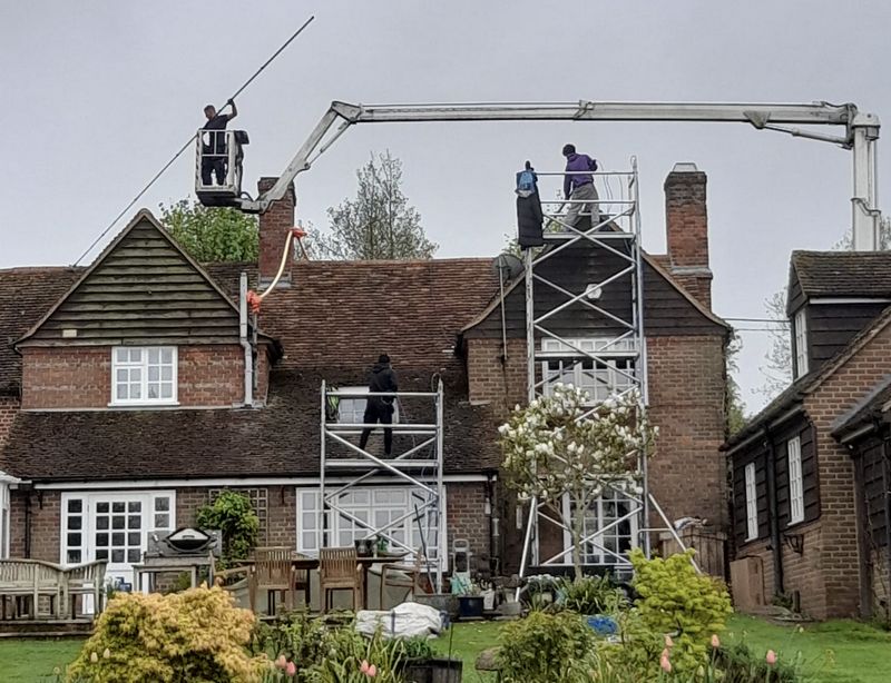The Roof Moss Cleaners using cherry picker and scaffolding to clean roof safely and professionally in Ringwood, Hampshire